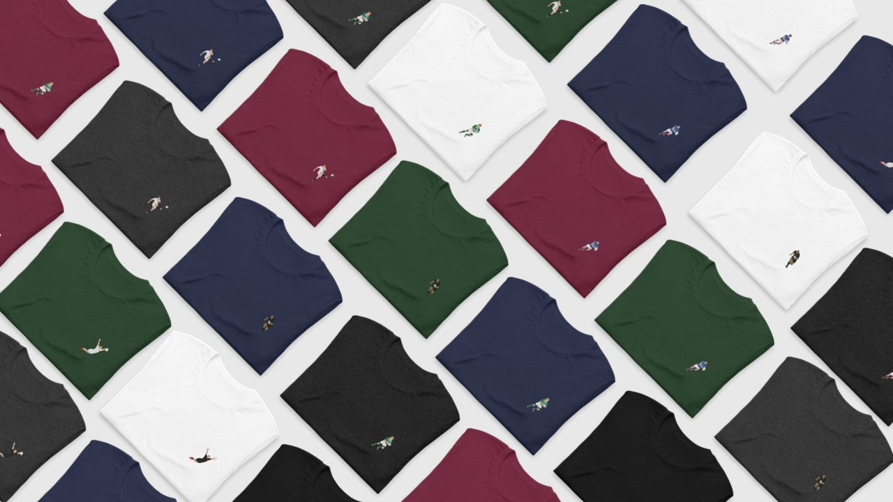 Several folded rugby T‑shirts showing minimalist embroidered rugby player silhouettes
